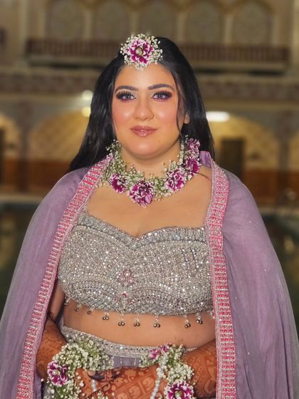 My bride Anmol during her Haldi ceremony, looking radiant in the golden hour light. The floral jewellery and soft makeup are a perfect match.
