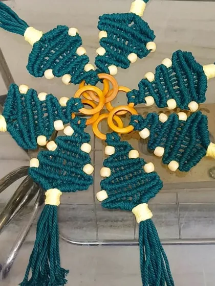 A unique set of macrame Christmas tree ornaments. These green, tree-shaped hangings with bead details are a wonderful addition to our festive macrame line.