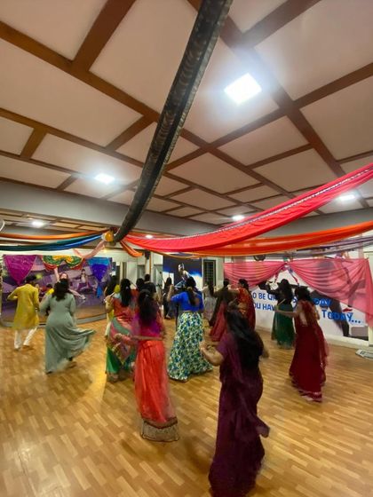 A shot from the back of the room during our Dandiya dance session, showing everyone moving together in their colorful traditional wear.