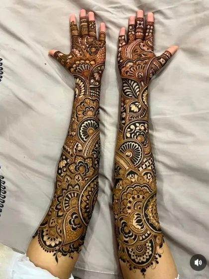 An example of my full-arm bridal mehandi featuring dense, flowing patterns. This style uses bold lines and delicate shading to create a striking look that covers the hands and arms completely.