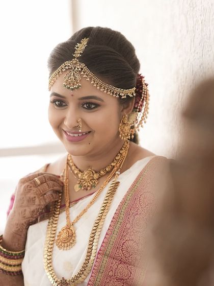 A beautiful reflection shot of the bride. Her airbrush makeup looks perfect from every angle.