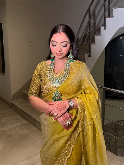 A full-length shot showing the elegance of this guest's attire. The makeup is soft and enhances her grace.