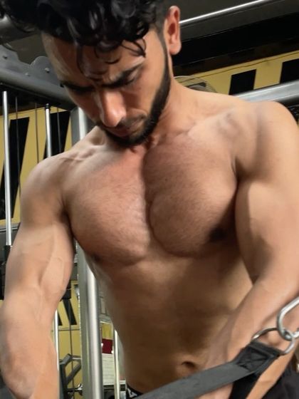 An "after" shot of Vikas, showcasing his well-defined chest and abs, a result of consistent, high-intensity training.