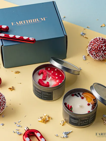 Another festive tin candle set, featuring candy canes and winter berries.
