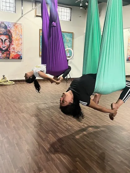 Mother and daughter practicing an aerial backbend together. This beautiful shot captures how fitness can be a shared, bonding experience at our studio.