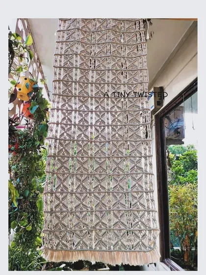 This is one of the 6-foot macramé panels, designed to be used as a beautiful, light-filtering backdrop or room separator. It’s handwoven with 100% pure cotton cords for a natural, elegant look.
