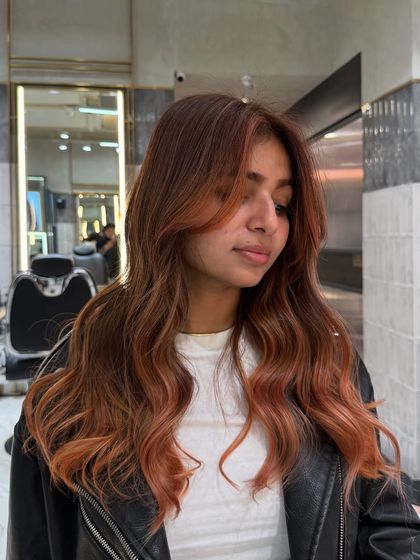 A dimensional ginger balayage perfect for autumn vibes. The warm, coppery tones are blended beautifully for a glowing, natural-looking finish.