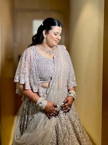 Delicate, dreamy, and divine. This bride looks absolutely angelic with her soft curls and a simple, elegant lehenga for her reception.