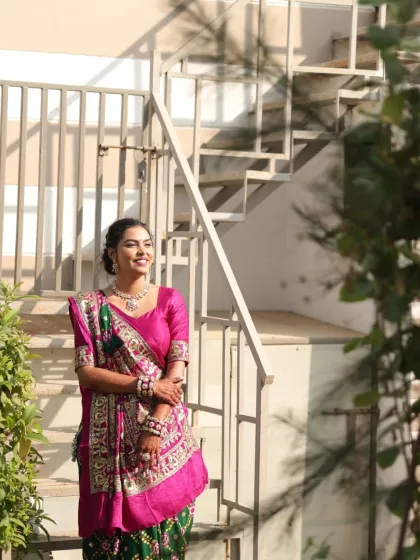 A full-length shot of the client, looking graceful in her traditional saree.