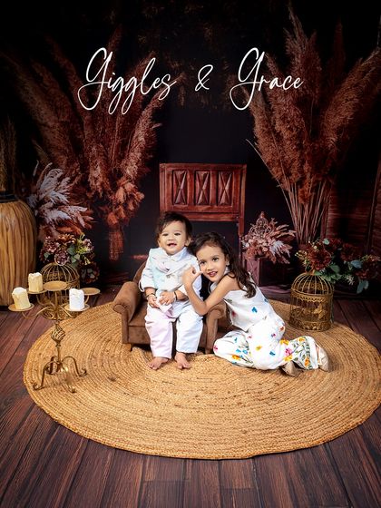 Giggles and grace. This portrait of two sweet siblings in a rustic, warm-toned setting perfectly captures their individual personalities and their lovely bond.