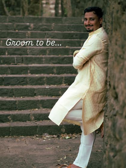 A confident and relaxed portrait of the groom-to-be. Leaning against a stone wall, his expression shows his excitement for the journey ahead.