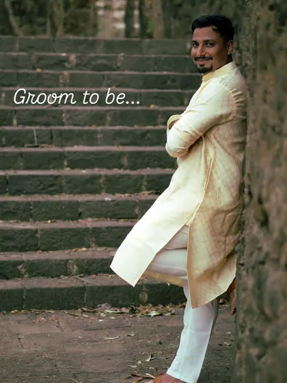 A confident portrait of the groom to be, leaning against ancient stone steps. This solo shot is an important part of the pre-wedding narrative, capturing his personality before the big day.