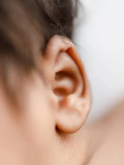 A close-up of a baby's tiny, perfectly formed ear.