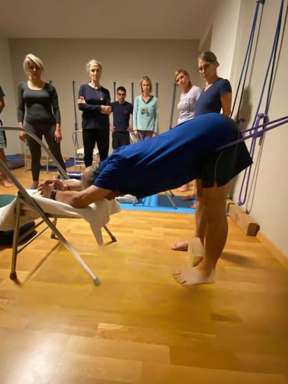 A supported backbend with a chair.