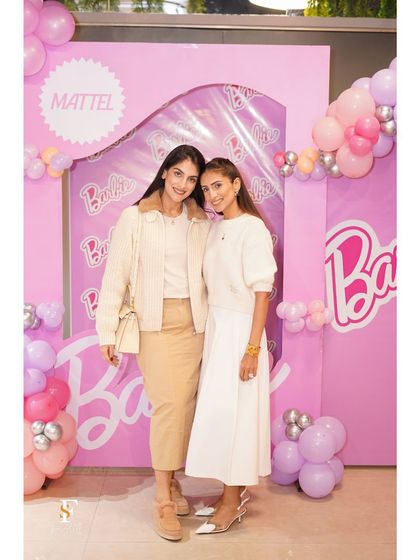 Two guests posing at the Barbie-themed party. Our beautiful decor ensures that every corner of the venue is photo-ready.
