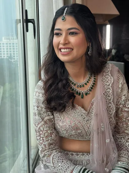 A happy, glowing bride. This close-up captures the essence of soft glam with its focus on radiant skin, a gentle smile, and makeup that enhances her natural joy.