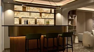 A render of the bespoke bar area within the neoclassic villa. The design features a backlit onyx wall and elegant pendant lighting, showcasing how I plan for both functionality and high-impact aesthetic moments.
