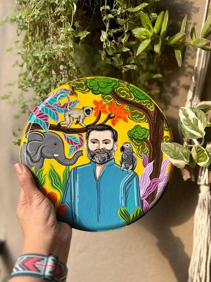 This personalized plate was created for an animal lover, featuring his portrait surrounded by his favorite animals like an elephant, a monkey, and a parrot in a jungle theme.