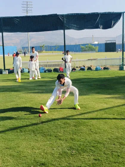A player practices the correct technique for fielding a ground ball, a fundamental skill we instill in all our cricketers.