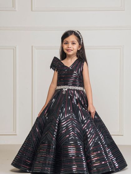 Our black taping gown features a modern, geometric pattern and a full ball gown skirt, perfect for a fashion forward princess.