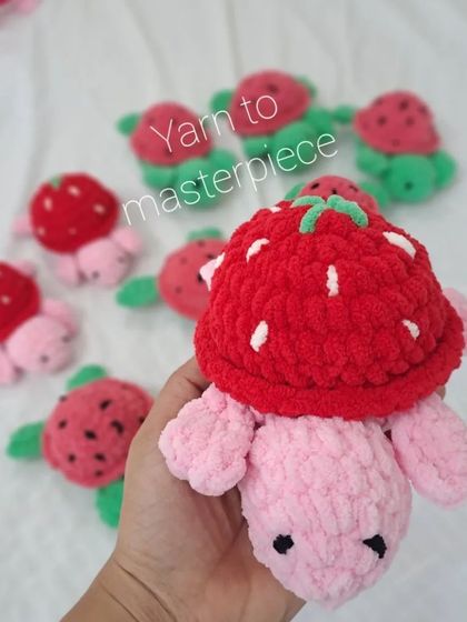 Holding a plush strawberry turtle.