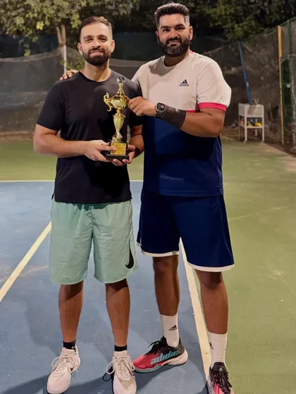 Celebrating a hard-fought victory. This trophy represents a win in the Men's 35+ doubles category at an ITF Masters tournament, a result of strategic play and strong partnership on the court.