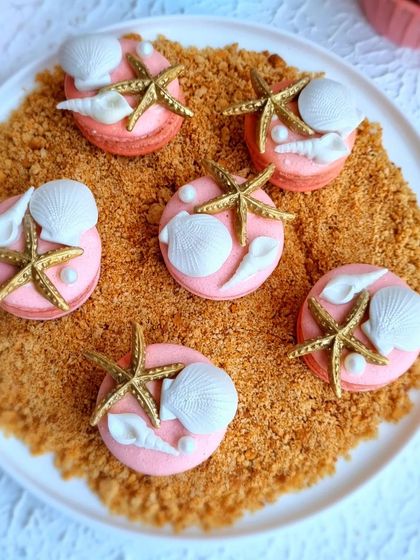 Ocean-themed macarons, decorated with tiny, hand-sculpted fondant shells and starfish. I teach how to make stable macaron shells and decorate them for any occasion.