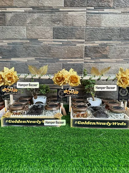 Two of our stunning black and gold 50th anniversary hampers. The theme was executed perfectly, from the custom tags to the golden floral decorations.