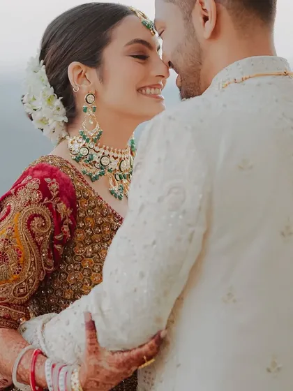 A beautiful, happy moment. The natural light highlights her glowing skin and the soft, romantic details of her bridal makeup.
