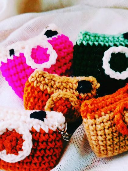 A collection of cute camera-shaped keychains in various colors. These are perfect for photographers or anyone who loves a quirky accessory.