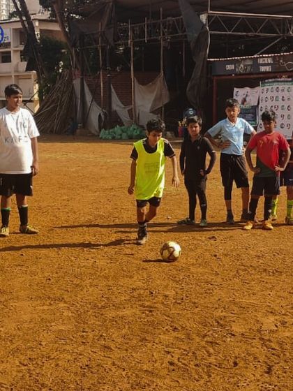 A young player dribbles the ball during a practice session. We focus on individual skill development within a team context to create well-rounded and effective players.