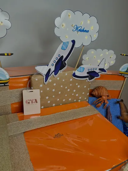 A detail shot of the airplane cutouts with personalized 'Krishna' clouds, part of the elaborate gift curation for the Ambani-Piramal twins.