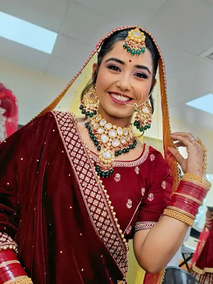 A bright, happy smile from the bride. The makeup is fresh and radiant, designed to last through a long day of celebrations.