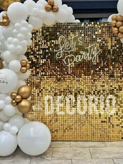 A gold shimmer wall is a versatile and high-impact backdrop for any celebration. Here, I've paired it with a classic white and gold balloon garland and a 'Let's Party' neon sign, creating a stylish photo booth area for a birthday, anniversary, or corporate event.
