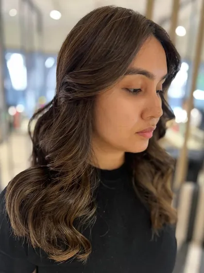 Another angle of the two-tone classic highlight blend, showing how the color frames the face and adds dimension to her mid-length to long hair.