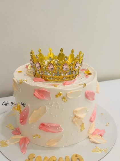 A royal treat for a royal soul. This elegant white cake is topped with a beautiful golden crown.