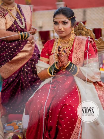 A candid moment from Priya's wedding ceremony. Her traditional Nauvari saree and serene expression capture the sanctity of the moment.