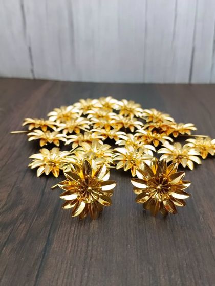 A collection of the gold-plated flowers, perfect for Ashtottara Sata Namavali (chanting 108 names).