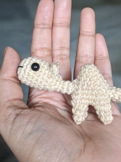 The tiny camel finger puppet, resting in the palm of my hand.