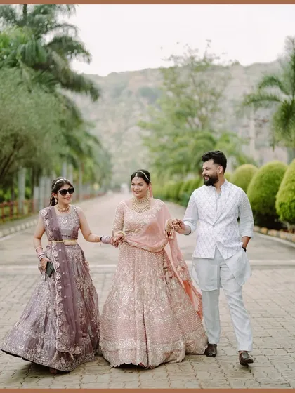 The bride walking with her siblings, a beautiful portrait capturing family bonds and coordinated outfits.