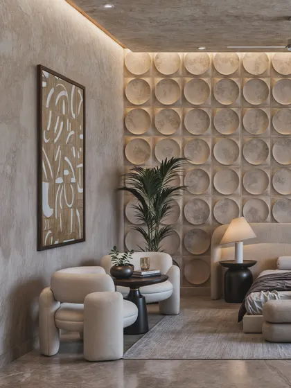 The seating area in this bedroom features sculptural armchairs, demonstrating how even small corners can be designed with artistic intention.