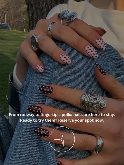 From the runway to your fingertips, polka dots are here to stay. This design features a mix of black and pink polka dot nails for a playful and chic look.