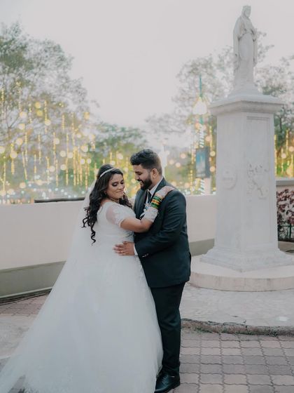 A beautiful portrait of Lawrence and Aliya after their church wedding. The classic pose in front of the statue creates a timeless and elegant memory.