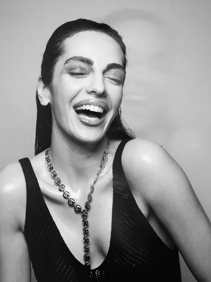 A joyful, candid moment that showcases a beautiful, natural makeup look. Even in black and white, you can see the radiant skin finish and clean styling.