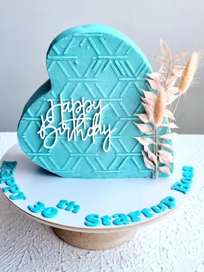 A modern standing heart cake with a geometric pattern. This gravity-defying structure is a fun challenge, and I teach how to build and decorate it.