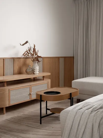 A serene living space from the 'Haus of Aureus' project, showcasing a minimalist aesthetic with a focus on natural wood tones and soft, neutral fabrics.