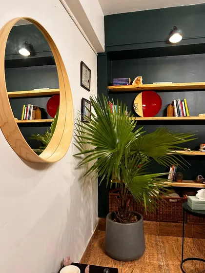 A cozy corner of our studio, with a well-stocked bookshelf and comfortable decor.