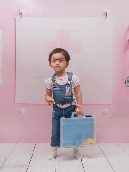 A thoughtful moment for our little doctor. Even the quiet, candid moments during a themed shoot can result in beautiful and character-filled portraits.