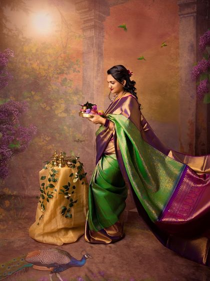 A stunning solo portrait of a mother-to-be in a green and purple paithani saree. The artistic backdrop and graceful pose make this a perfect Navratri portrait.