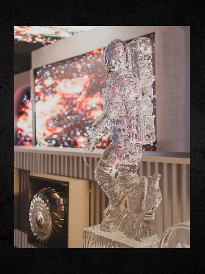 An intricately carved ice sculpture of an astronaut, demonstrating our commitment to executing a theme down to the smallest, most impressive details.